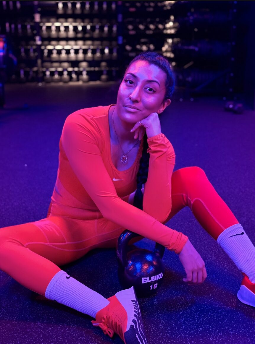 Vnisha resting with a kettlebell after a session